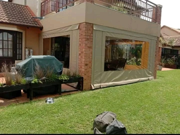 Outdoor blind enclosure beside a garden