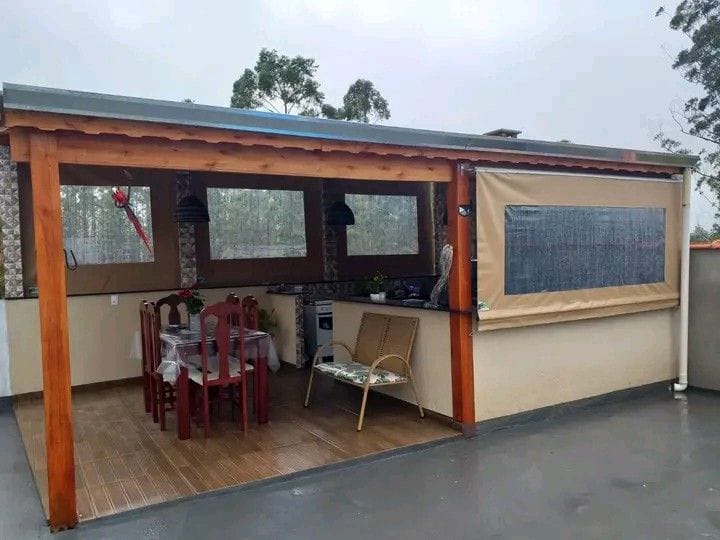 Clear outdoor blinds enclosing a timber patio