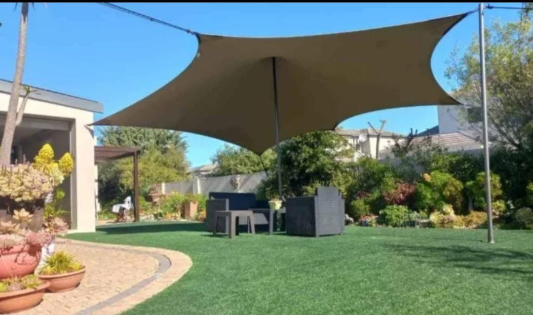 Brown shade sail over garden seating