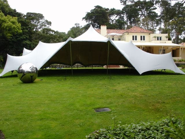 Large white stretch tent on a lawn