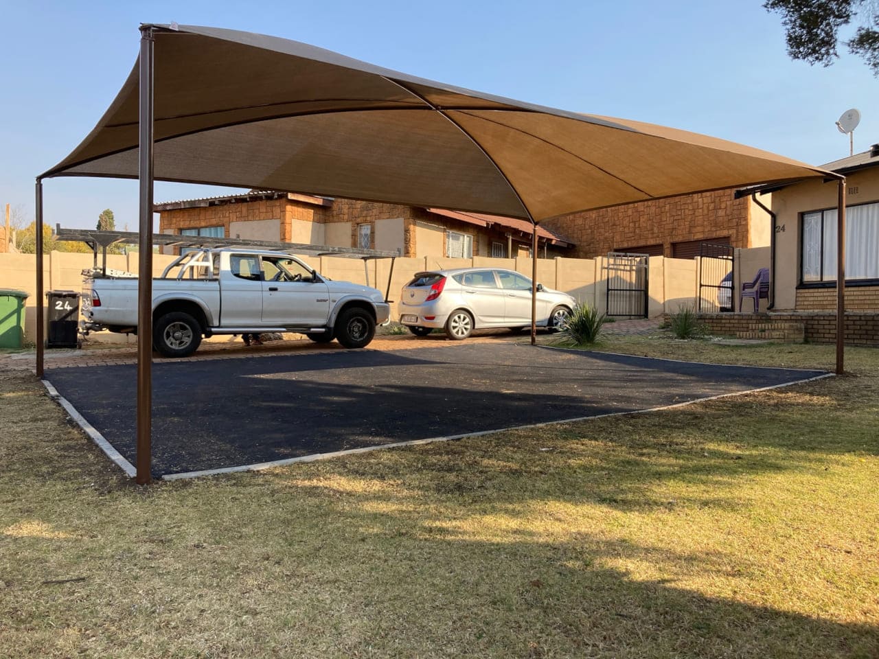 Shadeport covering parked vehicles